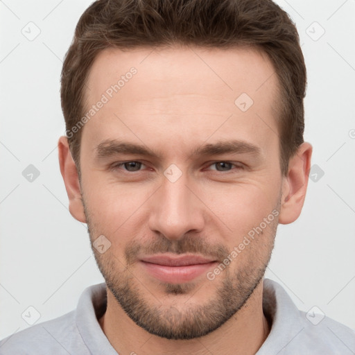 Joyful white young-adult male with short  brown hair and grey eyes