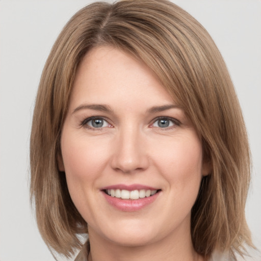 Joyful white young-adult female with medium  brown hair and green eyes