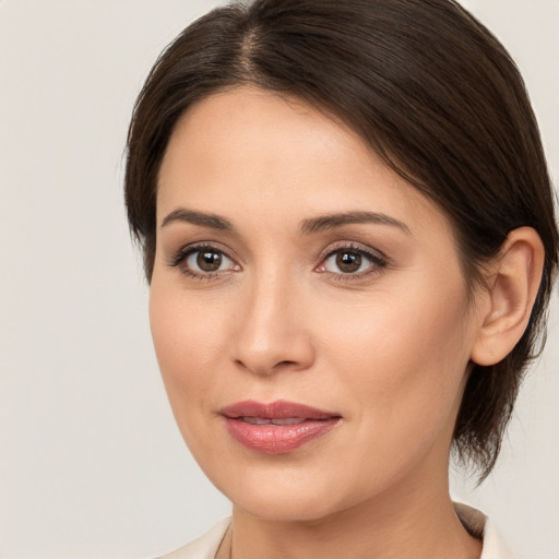 Joyful white young-adult female with medium  brown hair and brown eyes