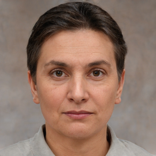 Joyful white adult female with short  brown hair and brown eyes