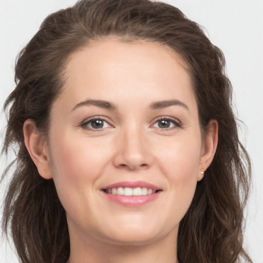 Joyful white young-adult female with long  brown hair and grey eyes