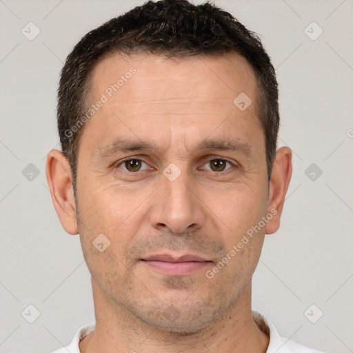 Joyful white adult male with short  brown hair and brown eyes