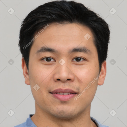 Joyful asian young-adult male with short  black hair and brown eyes