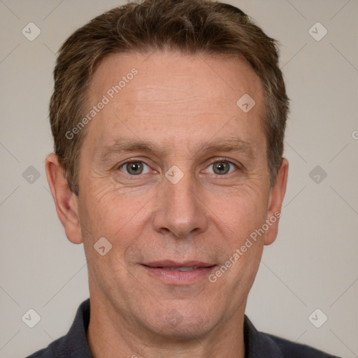 Joyful white adult male with short  brown hair and grey eyes