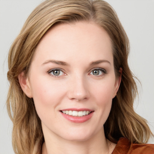 Joyful white young-adult female with medium  brown hair and blue eyes