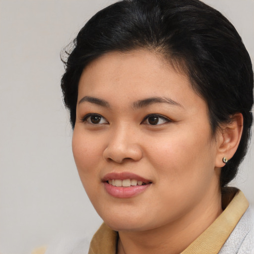 Joyful asian young-adult female with short  black hair and brown eyes