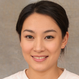 Joyful asian young-adult female with medium  brown hair and brown eyes