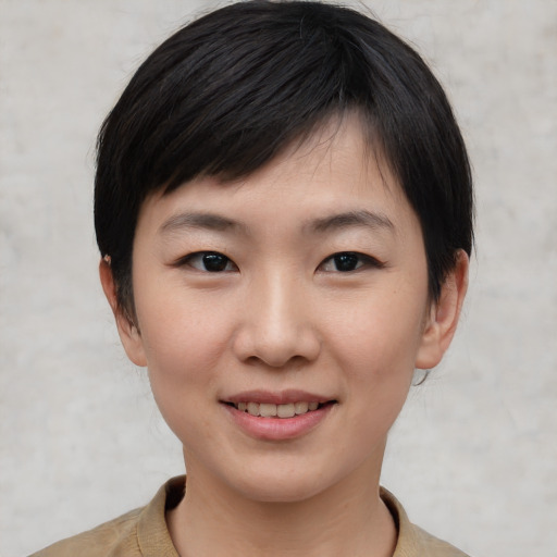 Joyful asian young-adult female with short  black hair and brown eyes