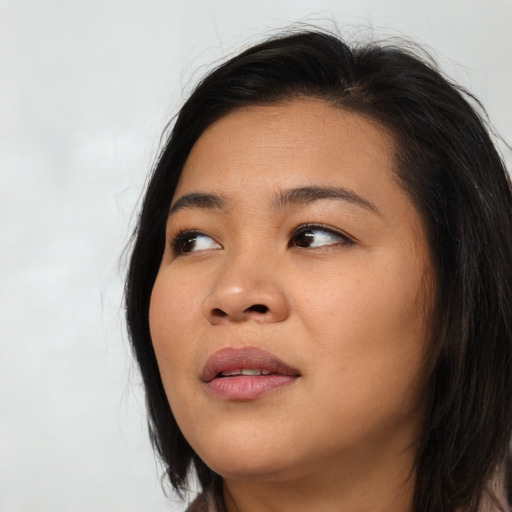 Joyful asian young-adult female with long  black hair and brown eyes