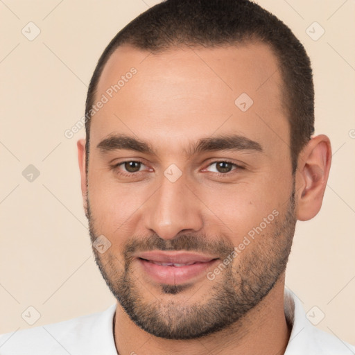 Joyful white young-adult male with short  brown hair and brown eyes