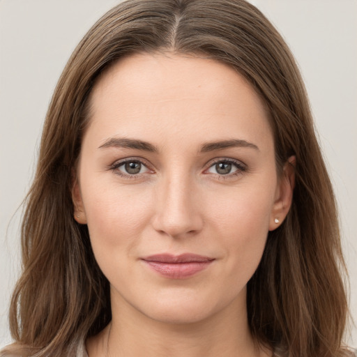 Joyful white young-adult female with long  brown hair and grey eyes