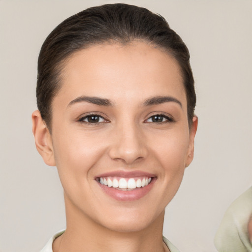 Joyful white young-adult female with short  brown hair and brown eyes