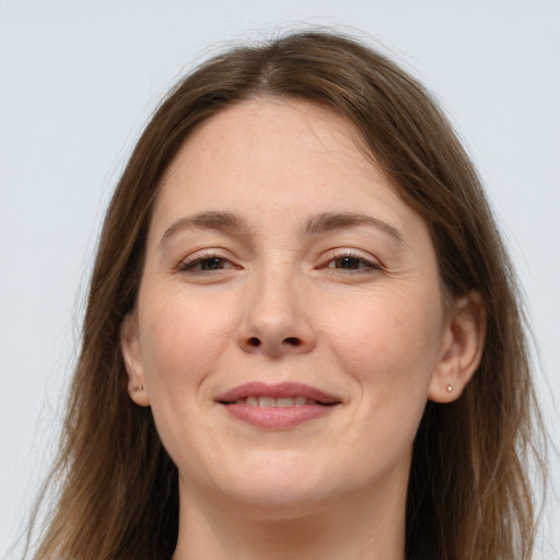 Joyful white adult female with long  brown hair and brown eyes