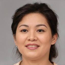 Joyful asian young-adult female with medium  brown hair and brown eyes