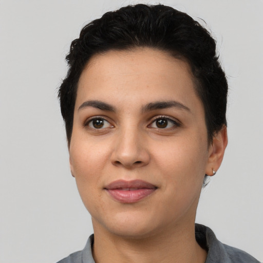 Joyful latino young-adult female with short  black hair and brown eyes