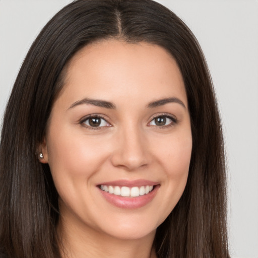 Joyful white young-adult female with long  brown hair and brown eyes