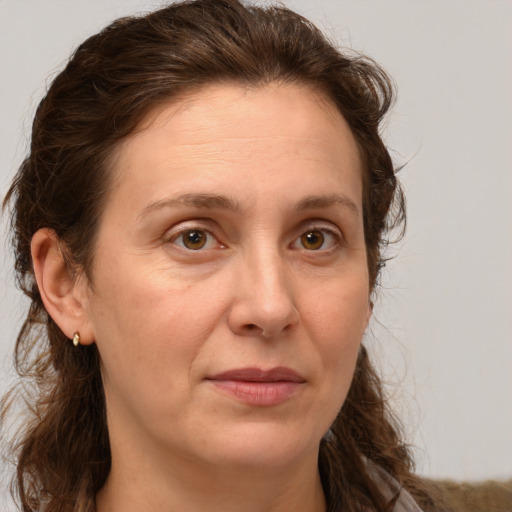 Joyful white adult female with long  brown hair and brown eyes