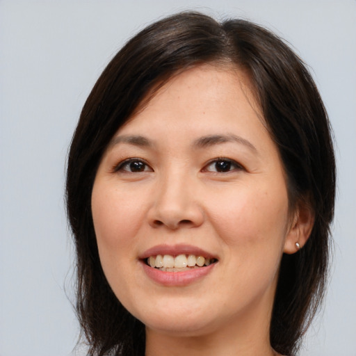 Joyful white young-adult female with medium  brown hair and brown eyes