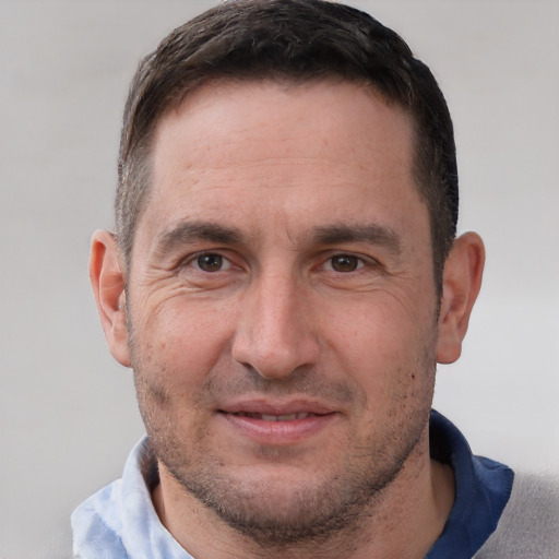 Joyful white adult male with short  brown hair and brown eyes