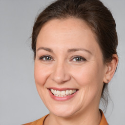 Joyful white adult female with medium  brown hair and brown eyes