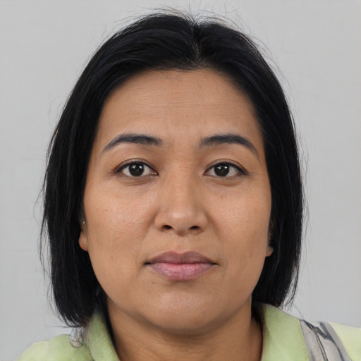 Joyful asian adult female with medium  brown hair and brown eyes