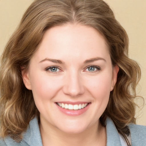 Joyful white young-adult female with medium  brown hair and blue eyes