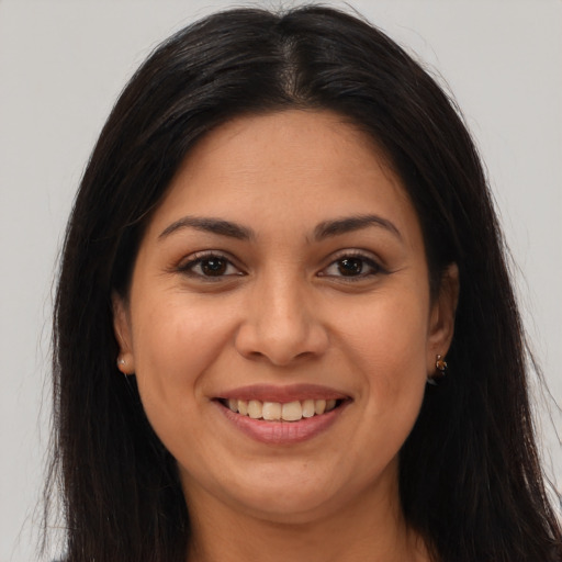 Joyful asian young-adult female with long  brown hair and brown eyes