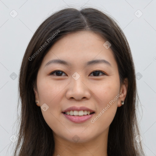 Joyful asian young-adult female with long  brown hair and brown eyes