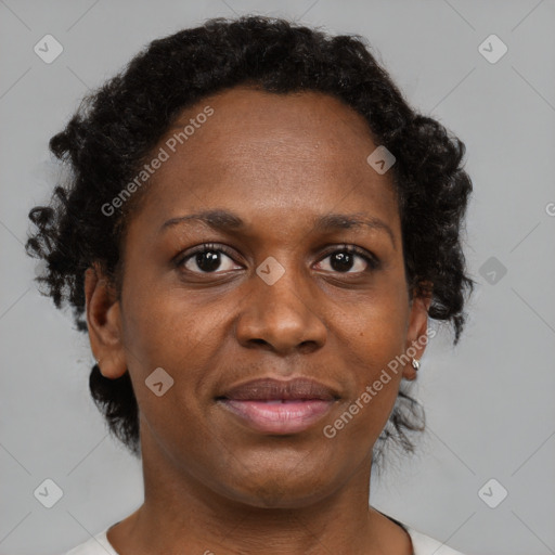 Joyful black adult female with short  brown hair and brown eyes