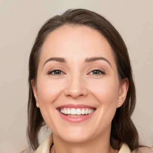 Joyful white young-adult female with medium  brown hair and brown eyes