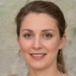 Joyful white young-adult female with medium  brown hair and green eyes