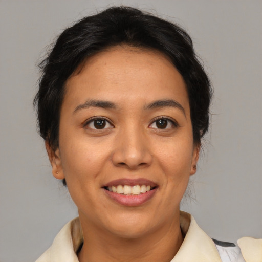 Joyful asian young-adult female with medium  brown hair and brown eyes