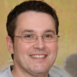 Joyful white adult male with short  brown hair and brown eyes