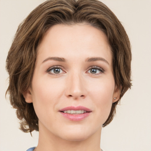 Joyful white young-adult female with medium  brown hair and green eyes