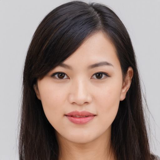 Joyful asian young-adult female with long  brown hair and brown eyes