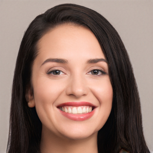 Joyful white young-adult female with long  black hair and brown eyes