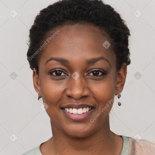 Joyful black young-adult female with short  black hair and brown eyes