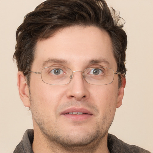 Joyful white adult male with short  brown hair and grey eyes