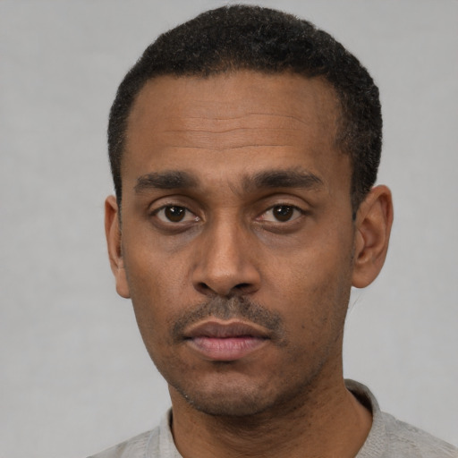 Neutral latino adult male with short  black hair and brown eyes