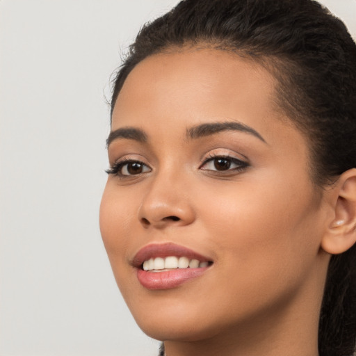 Joyful latino young-adult female with long  brown hair and brown eyes