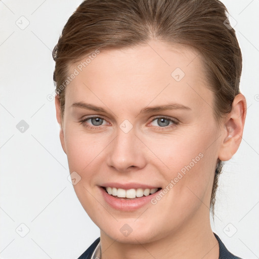 Joyful white young-adult female with short  brown hair and grey eyes