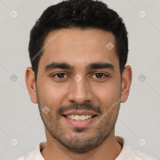 Joyful latino young-adult male with short  black hair and brown eyes