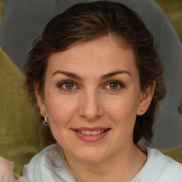 Joyful white young-adult female with medium  brown hair and green eyes