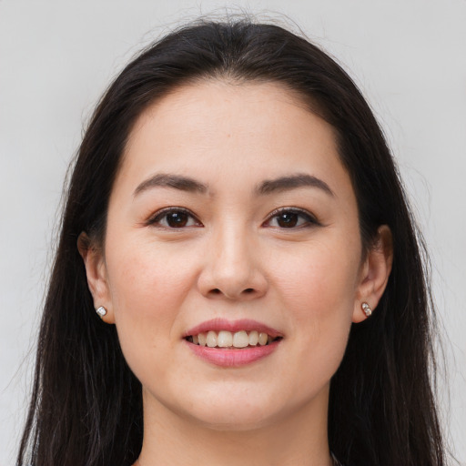 Joyful white young-adult female with long  brown hair and brown eyes