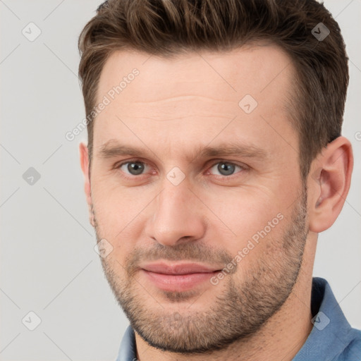 Joyful white adult male with short  brown hair and grey eyes