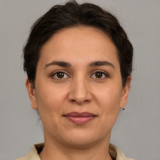 Joyful white adult female with medium  brown hair and brown eyes