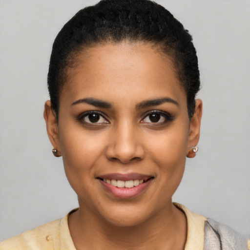 Joyful latino young-adult female with short  black hair and brown eyes