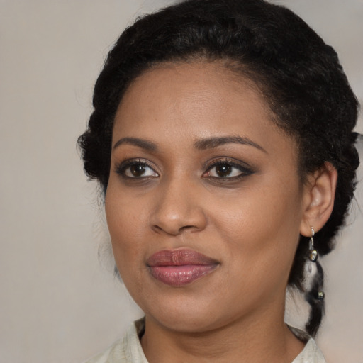 Joyful black young-adult female with medium  brown hair and brown eyes