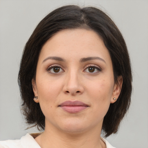 Joyful white young-adult female with medium  brown hair and brown eyes