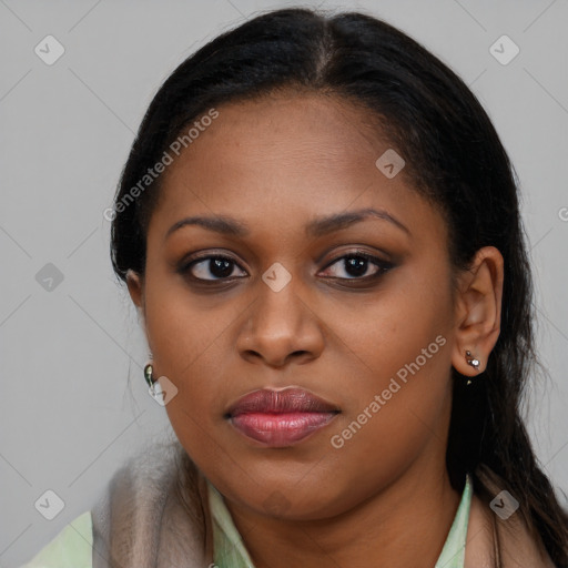 Joyful black young-adult female with long  brown hair and brown eyes